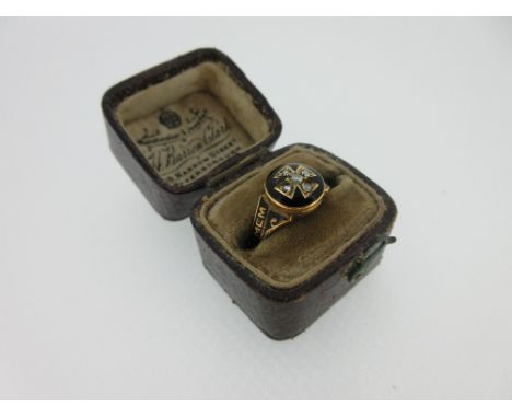 An 1870 diamond and enamel memorial ring with hinged compartment, the ring with a circular head holding a Greek cross set wit