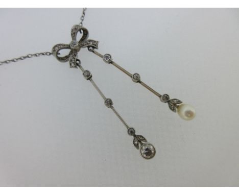 A Belle Époque diamond and pearl negligée necklace, designed as a diamond set bow from which suspend two knife edge bars with