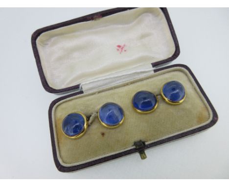 A pair of French 18ct gold and sapphire double ended cufflinks, each end with a near-round cabochon light blue sapphire joine