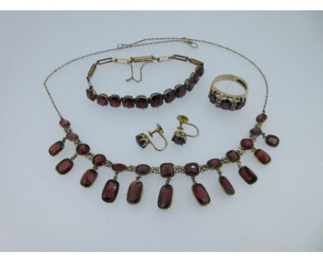 A garnet fringe necklace and matched suite of garnet jewellery, the necklace spectacle set to the front with a graduated line