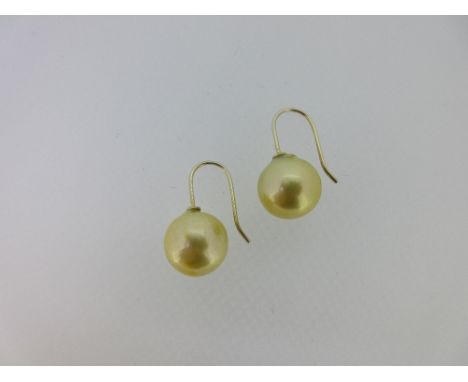 A pair of golden coloured pearl earpendants, each a 12.5mm probably freshwater cultured pearl of pale golden colour, slightly