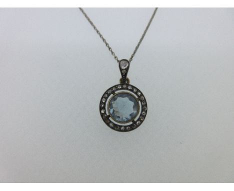 An aquamarine and diamond pendant on a chain, the round facetted aquamarine in a millegrain edged collet to an open linear bo