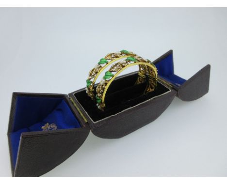 A pair of fine 19th century hinged bangles with enamel and seed pearls, each designed as twin parallel bars all around the wr