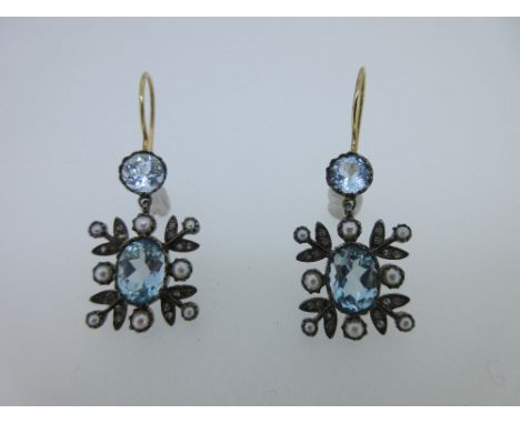 A pair of blue topaz, seed pearl and diamond earpendants, each hook fronted by a round cut blue topaz which suspends a simila