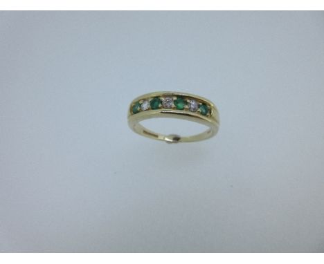 A 9ct gold emerald and diamond half eternity style ring, comprising four round facetted emeralds spaced with three round bril