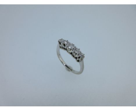 An Edwardian style five stone diamond ring, the graduating round old brilliant cut diamonds claw set to a coronet gallery, wi