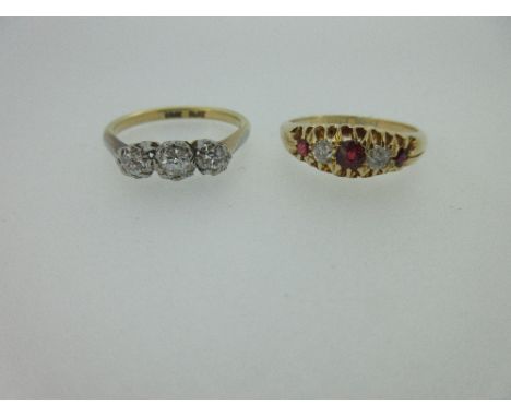 A diamond three stone ring and a ruby and diamond five stone ring, the first claw set with three graduated old round brillian