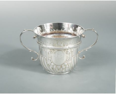 A George II silver two handled porringer, possibly by Peter Simon, London 1726, of traditional half gadrooned form with reede