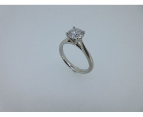 A single stone diamond ring set in platinum, the round brilliant cut diamond in a raised four claw setting, with tapering sho