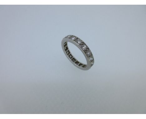 A full hoop diamond eternity ring, with nineteen round brilliant cut diamonds claw set in unmarked white metal which tests fo