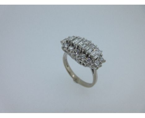 A 20th century diamond cluster ring set in 18ct white gold, the central row of five baguette cut diamonds bordered by a total