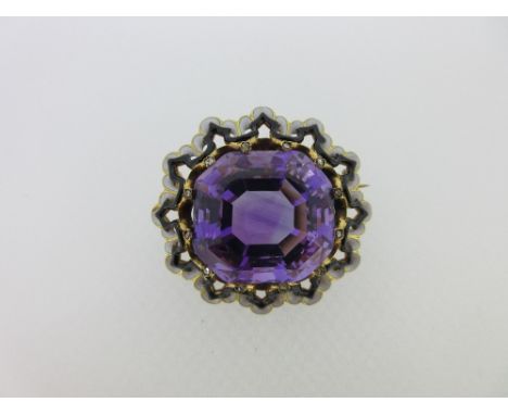 A French 19th century amethyst, diamond and enamel brooch, the large cushion cut amethyst held by twelve raised claws each to