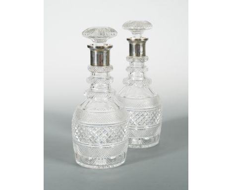 A pair of George V cut glass decanters with silver collars, by Garrard &amp; Co, London 1925, of mallet shaped form with hobn
