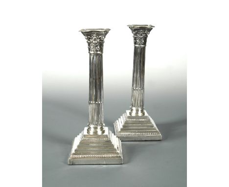 A pair of Edward VII silver candlesticks, by Harrison Brothers &amp; Howson, Sheffield 1908, 'Corinthian' style, with square,