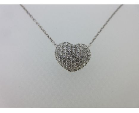 A diamond set heart shaped pendant and chain, the slightly domed heart pendant covered with pavé set round brilliant cut diam
