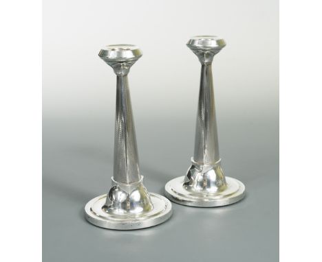 A pair of George V silver candlesticks, maker's mark indistinct, Birmingham 1921, with circular dished and stepped base, tria