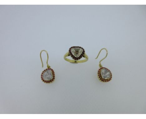 A silver gilt ruby and diamond cluster ring and earpendant suite, the ring rub over set with a triangular shaped foil backed 