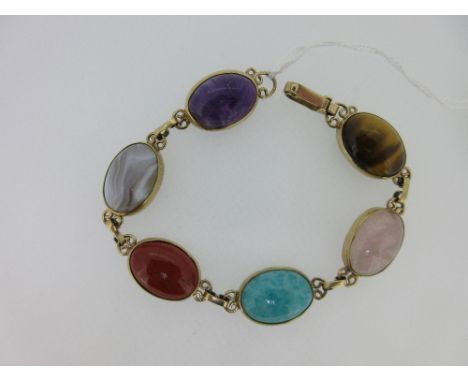 A bracelet set with six different hardstones, the oval cabochon stones, variously amethyst, grey banded agate, jasper, amazon
