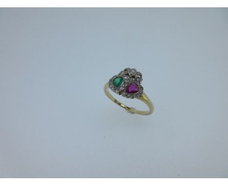 A ruby, emerald and diamond lover's ring, the offset millegrain edged pearshaped emerald and ruby surrounded by pavé set rose