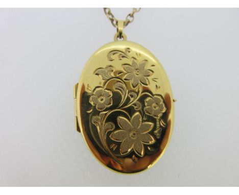 A 9ct gold hinged locket and chain, the locket of oval form with engraved four flower motif, the reverse plain with brushed s