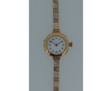 An unsigned 9ct gold lady's wristwatch, circa 1914, the circular white dial, 20mm diameter, with black Arabic numerals (numbe