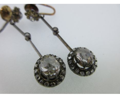 A pair of rose cut diamond earpendants made from parts of an antique necklace, the front of each screwback fitting set with a
