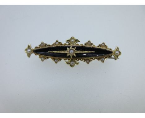An onyx and pearl set memorial bar brooch, the central concave navette shaped onyx topped with an elongated star setting cont