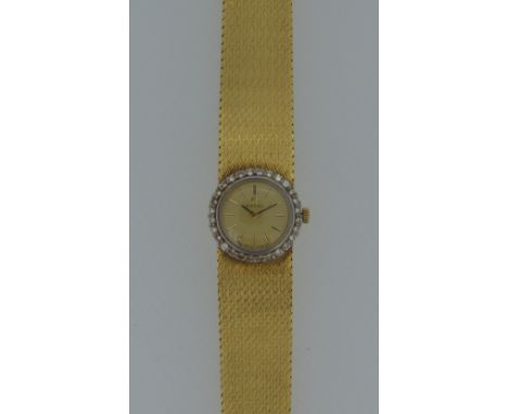 Omega - A lady's 18ct gold and diamond wristwatch, circa 1969, the signed circular champagne dial, 20mm diameter, with gold c