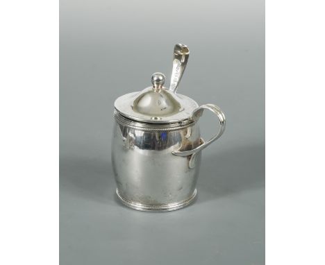 A George III silver barrel shaped mustard and spoon, by Michael Plummer, London 1795, with reed and beaded border and domed h