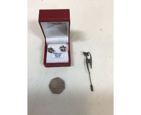 A pair of sterling silver earrings fashioned as flowers, a silver cat stick pin and a 50p piece