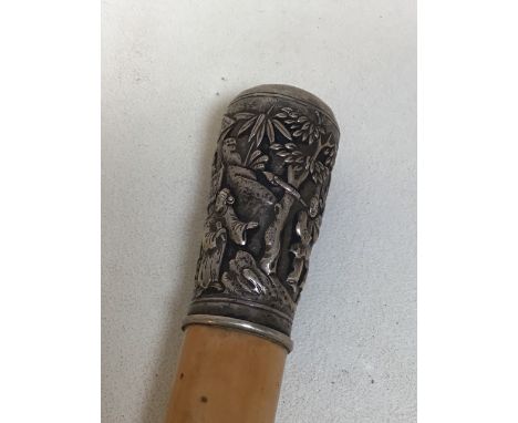 A walking stick with white metal top carved with Chinese scene and figures 