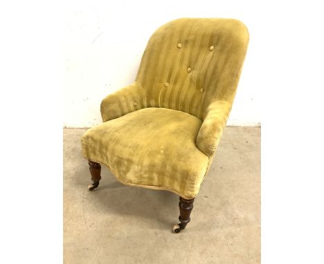 A Victorian button backed upholstered nursing char with turned legs and ceramic and brass castors. Seat height H:34cm