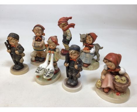 A quantity of Goebel Hummel figures including chimney sweeps, goose girls and others. Tallest 13cm