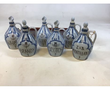 Buchan stoneware decanters - 6 including Amontillado, Brandy, Scotch, Gin, Sherry and Whisky and a glass topped tray 