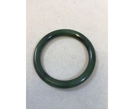 A spinach jade bangle approx 7.5cm diameter 