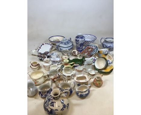A box of mixed ceramics including a quantity of small jugs, Poole Pottery tea cups 