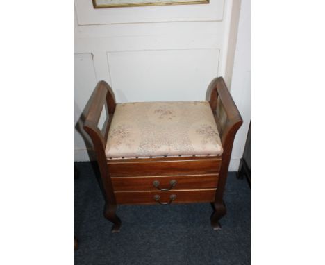 An early 20th century mahogany piano stool, with hinged box seat above two drawers with drop down fronts, on cabriole legs
