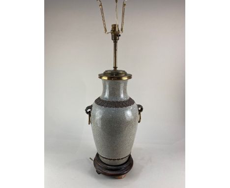 A Chinese porcelain vase table lamp, the crackle glaze, metal mounted with ring handles, on hardwood stand, 59cm high