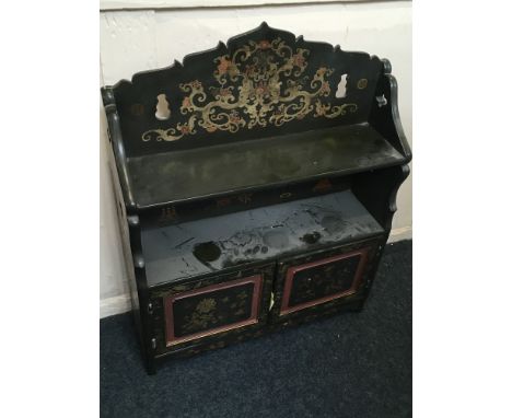 A Chinoiserie green lacquered wall cabinet, two panelled cupboard doors with shelf above, decorated with vases, flowers and s