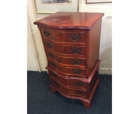 A George III style small yew bowfront side table of six drawers, with drop handles on bracket feet, 45cm