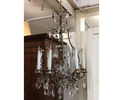 A large gilt metal eight branch chandelier light fitting, hung with large clear, pink and yellow glass drops, approx. 97cm hi