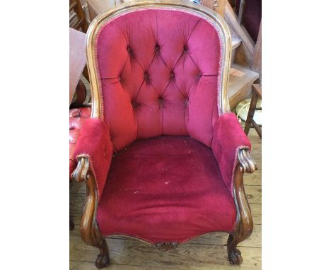 A Victorian Mahogany spoon back armchair with maroon button back draylon on scroll feet