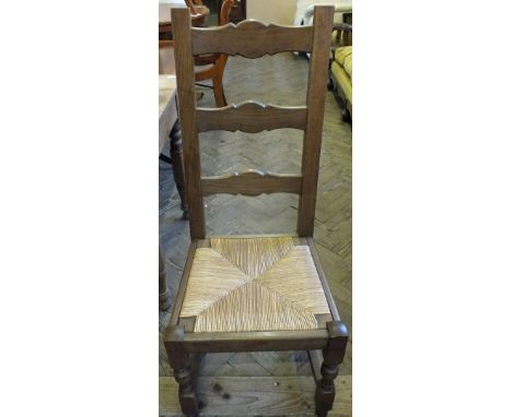A set of six Oak ladder back rush seated dining chairs