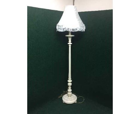 A carved painted standard lamp and shade 