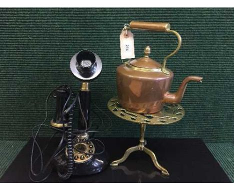 A reproduction candlestick telephone, brass and copper kettle and a brass trivet depicting a squirrel 
