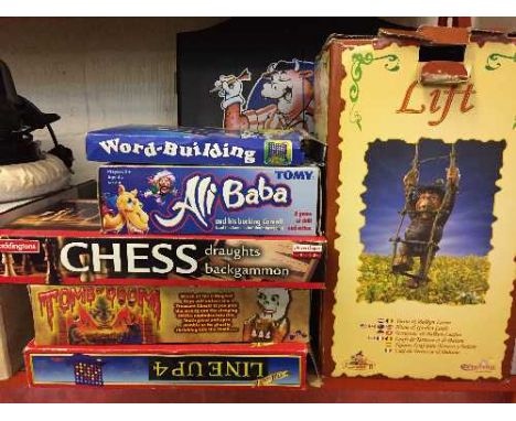 A quantity of assorted board games, dart board in cabinet, framed Newcastle United print, Halogen oven, car buffer etc.