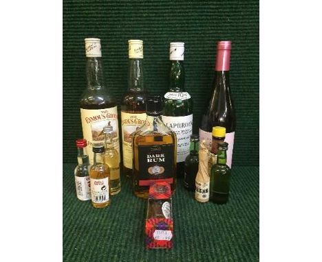 A basket of assorted bottles of Scotch whiskey, bottle of wine, bottle of rum, miniatures etc 