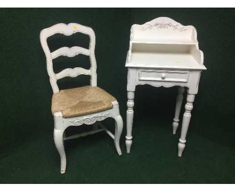 A painted pine telephone table fitted with a drawer together with a pine rush seated ladder backed chair