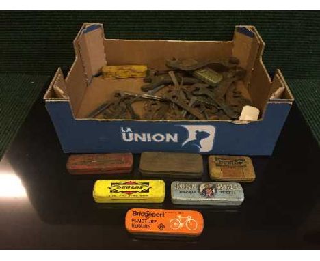 A box of a collection of vintage cycle tools and puncture repair kits 