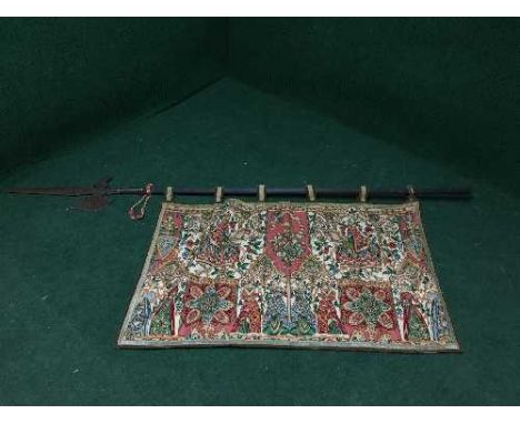 A Halberd together with a hanging tapestry 